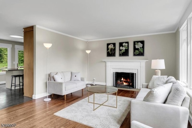 34 Keats Rd, Bernards Twp, NJ 07920 - living area with plenty of natural light, baseboards, a brick fireplace, wood finished floors, and crown molding