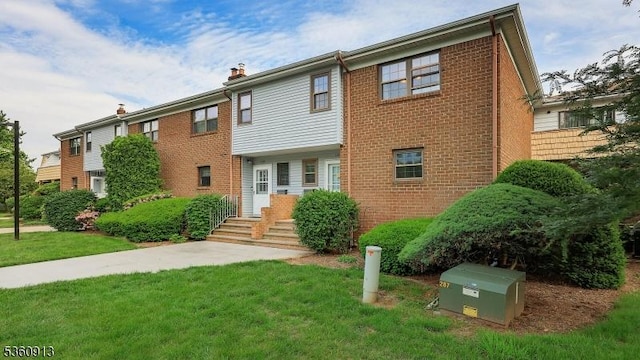 1106 Tudor Ct, Hillsborough Twp, NJ 08844 - view of front of property featuring brick siding, a front lawn, and a chimney