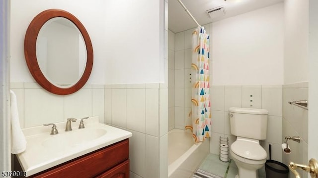 1106 Tudor Ct, Hillsborough Twp, NJ 08844 - full bathroom with tile walls, vanity, toilet, shower / tub combo with curtain, and a wainscoted wall