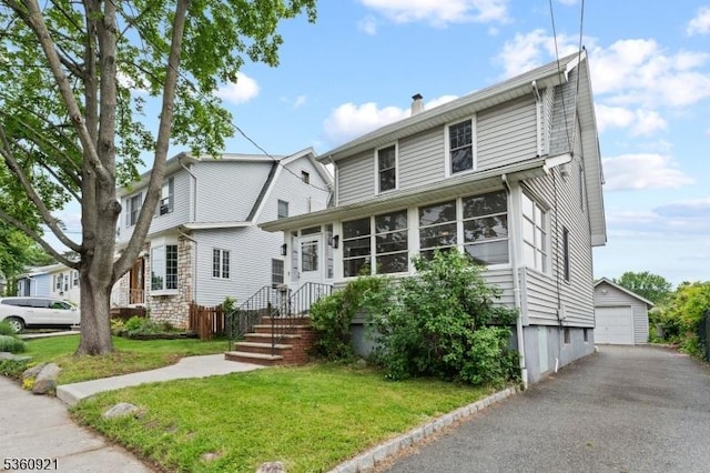 10 Garden Pl, Cranford Twp, NJ 07016 - view of front of home with an outdoor structure, a detached garage, a chimney, and a front lawn