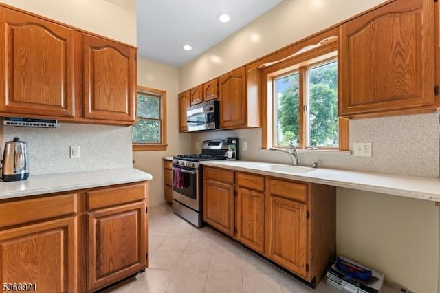 10 Garden Pl, Cranford Twp, NJ 07016 - kitchen with appliances with stainless steel finishes, a sink, light countertops, and backsplash