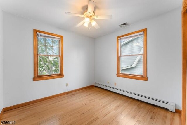 10 Garden Pl, Cranford Twp, NJ 07016 - unfurnished room featuring a baseboard heating unit, light wood finished floors, baseboards, and ceiling fan
