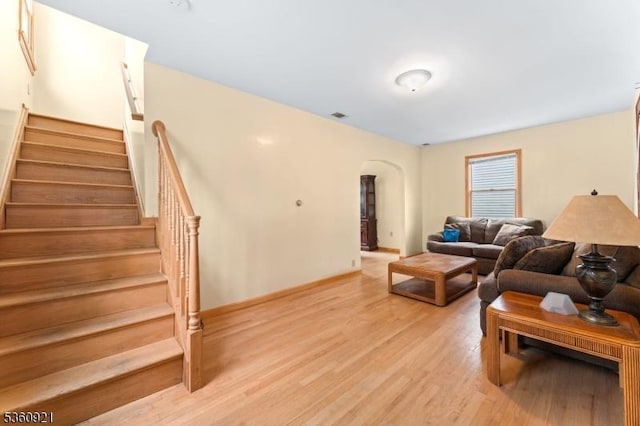 10 Garden Pl, Cranford Twp, NJ 07016 - living area with arched walkways, light wood-style flooring, stairs, and baseboards