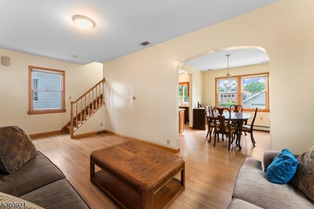 10 Garden Pl, Cranford Twp, NJ 07016 - living area with arched walkways, light wood-type flooring, baseboards, and stairway