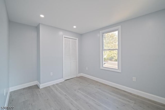 191 Harrison St, Passaic City, NJ 07055 - unfurnished bedroom featuring light wood-style flooring, a closet, baseboards, and recessed lighting