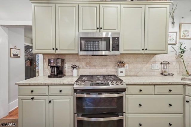 2 Broad St, Stockton Boro, NJ 08559 - kitchen featuring stainless steel appliances, decorative backsplash, and cream cabinetry
