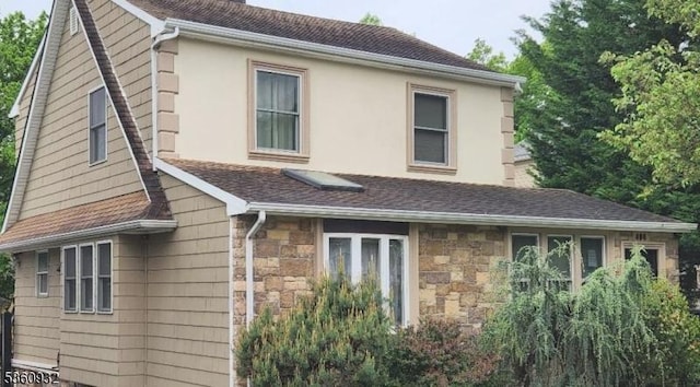 406 Dixie Ave, Hawthorne Boro, NJ 07506 - view of home's exterior featuring stone siding, a shingled roof, and stucco siding