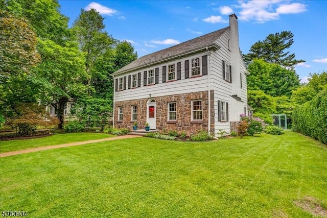 168 Grove St, Montclair Twp, NJ 07042 - view of front of property with a front yard, a chimney, and stone siding