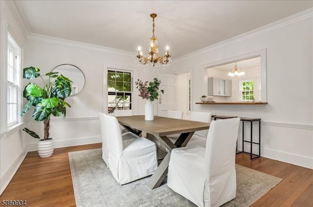 168 Grove St, Montclair Twp, NJ 07042 - dining space with a chandelier, crown molding, wood finished floors, and baseboards