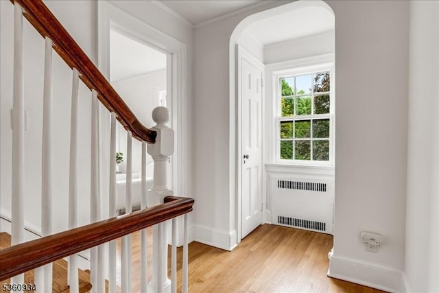 168 Grove St, Montclair Twp, NJ 07042 - entryway with radiator heating unit, light wood-type flooring, stairway, arched walkways, and baseboards