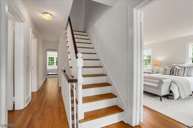 168 Grove St, Montclair Twp, NJ 07042 - stairs featuring wood finished floors, healthy amount of natural light, arched walkways, and baseboards