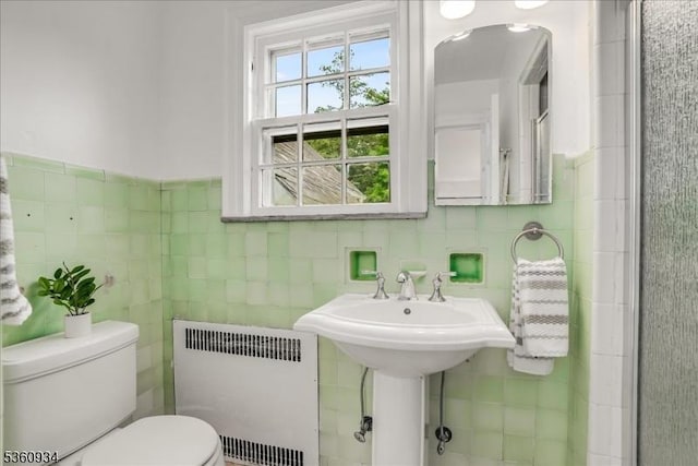168 Grove St, Montclair Twp, NJ 07042 - bathroom featuring radiator, tile walls, and toilet