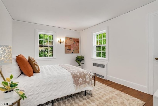 168 Grove St, Montclair Twp, NJ 07042 - bedroom with radiator, wood finished floors, and baseboards