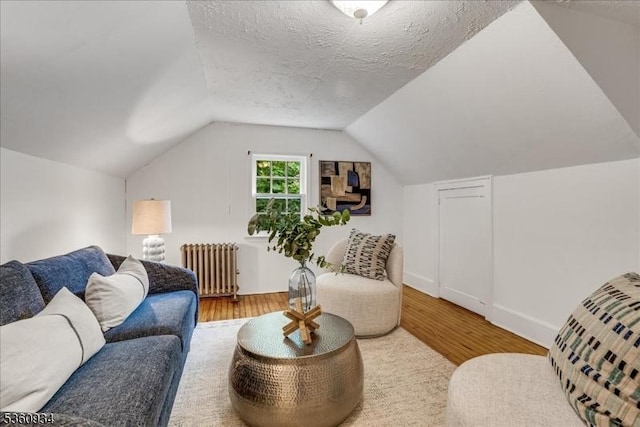 168 Grove St, Montclair Twp, NJ 07042 - living room featuring radiator heating unit, wood finished floors, and lofted ceiling