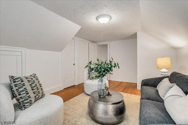 168 Grove St, Montclair Twp, NJ 07042 - living area featuring light wood-type flooring, a textured ceiling, and lofted ceiling