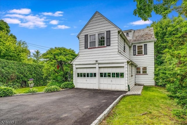 168 Grove St, Montclair Twp, NJ 07042 - traditional-style house with an attached garage, driveway, and a front lawn