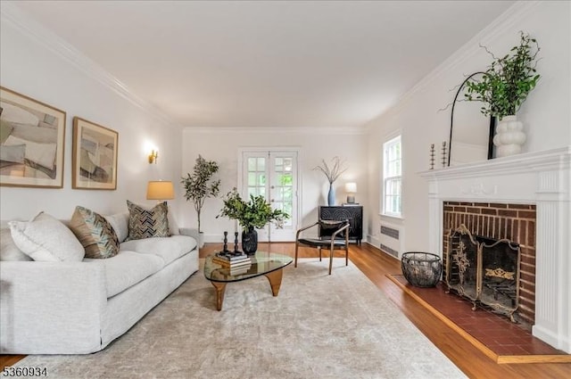 168 Grove St, Montclair Twp, NJ 07042 - living area featuring wood finished floors, crown molding, a fireplace, and french doors