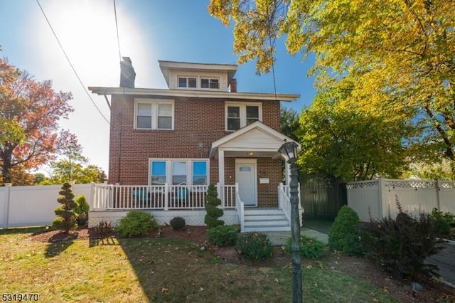 770 Stone St, Rahway City, NJ 07065 - american foursquare style home with brick siding, a chimney, and covered porch