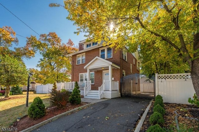 770 Stone St, Rahway City, NJ 07065 - american foursquare style home with brick siding and a gate