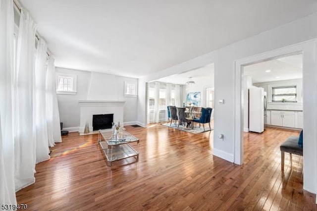 770 Stone St, Rahway City, NJ 07065 - living room featuring wood-type flooring, a fireplace with flush hearth, and baseboards