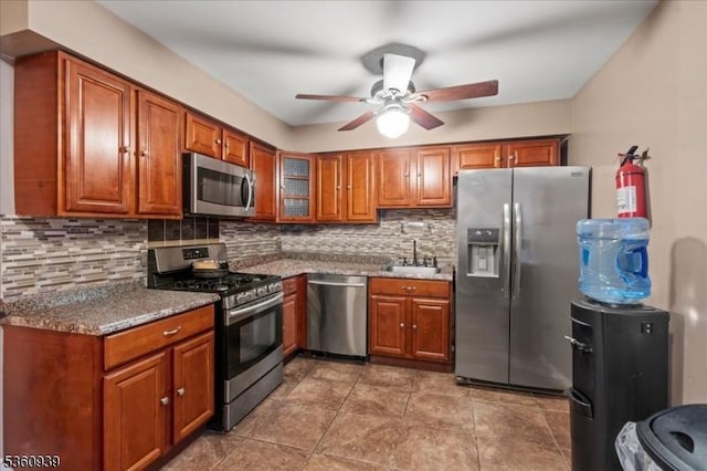 804 Orchard Meadows Dr, Union Twp, NJ 07083 - kitchen with appliances with stainless steel finishes, a ceiling fan, brown cabinetry, and tasteful backsplash