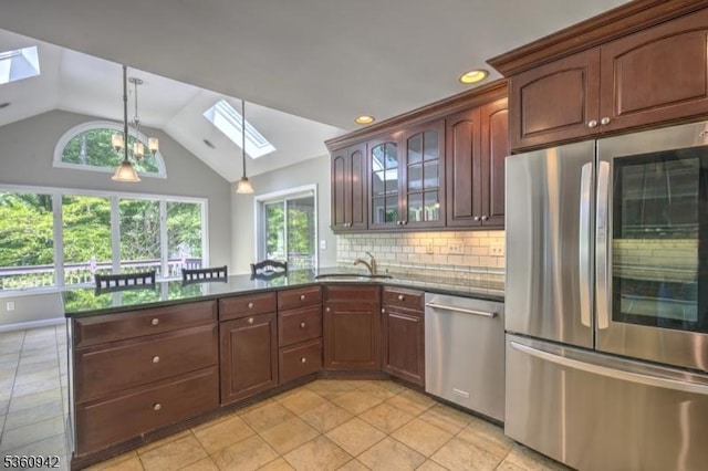 3 Rolling Hill Dr, Morris Twp, NJ 07960 - kitchen featuring appliances with stainless steel finishes, a skylight, a peninsula, a sink, and lofted ceiling