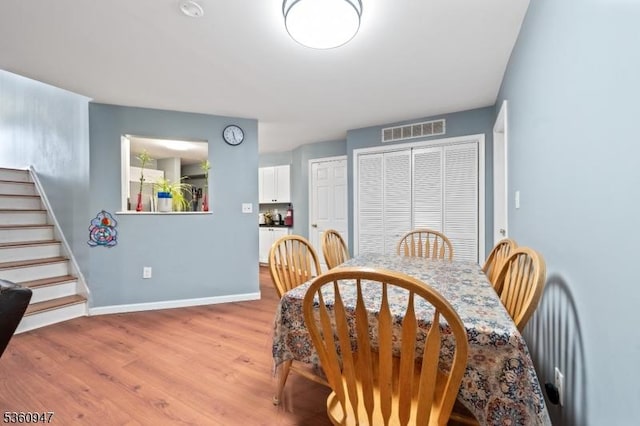 203 Rhoads Dr, Condo, Montgomery Twp, NJ 08502 - dining area featuring light wood-type flooring, baseboards, and stairway