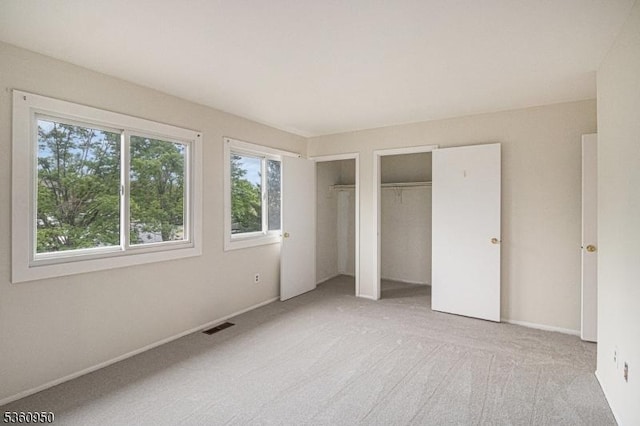31 Canterberry Cir, Raritan Twp, NJ 08822 - unfurnished bedroom with two closets, light colored carpet, and baseboards