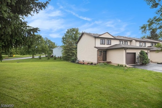 31 Canterberry Cir, Raritan Twp, NJ 08822 - view of home's exterior featuring asphalt driveway, a yard, and a garage