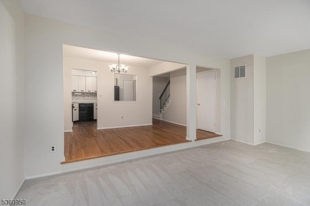 31 Canterberry Cir, Raritan Twp, NJ 08822 - unfurnished living room featuring stairs, a chandelier, baseboards, and carpet floors
