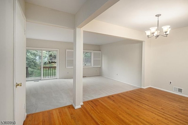 31 Canterberry Cir, Raritan Twp, NJ 08822 - spare room with a chandelier, light wood-type flooring, baseboards, and light colored carpet