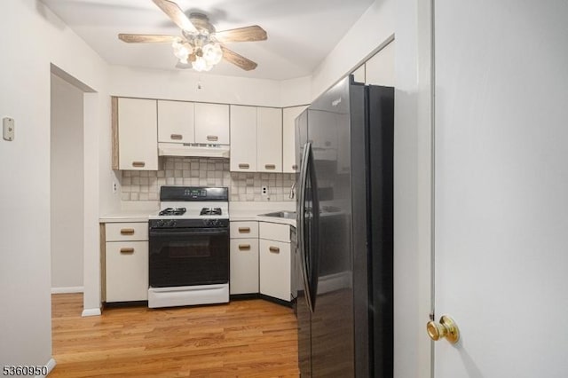 31 Canterberry Cir, Raritan Twp, NJ 08822 - kitchen with white gas range, freestanding refrigerator, under cabinet range hood, a ceiling fan, and light countertops