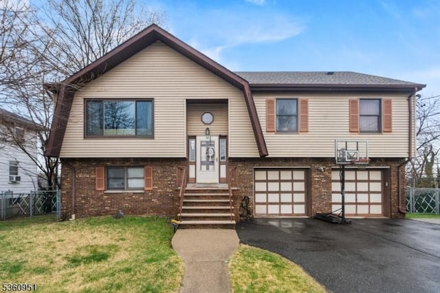 55 Jefferson St, Clifton City, NJ 07014 - split foyer home featuring asphalt driveway, brick siding, and an attached garage