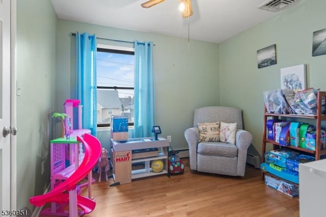 55 Jefferson St, Clifton City, NJ 07014 - rec room with ceiling fan, wood finished floors, a baseboard radiator, and baseboard heating
