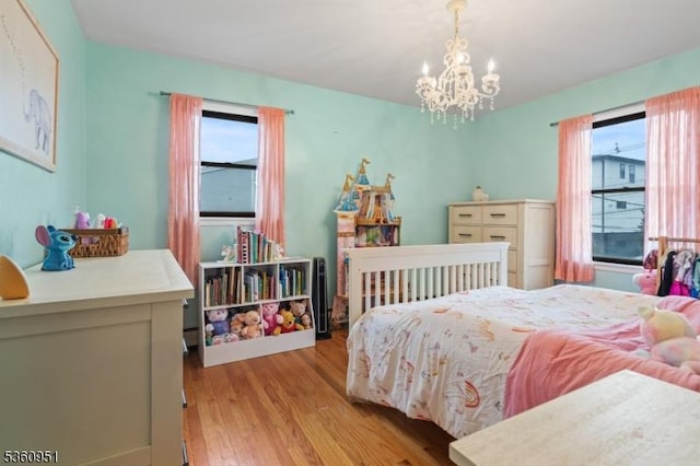 55 Jefferson St, Clifton City, NJ 07014 - bedroom with light wood-type flooring and a chandelier