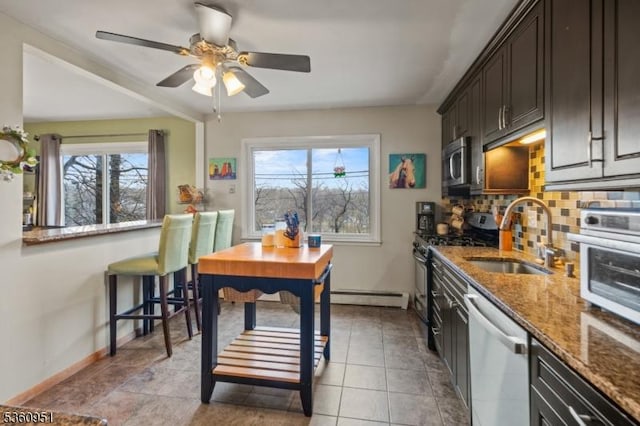 55 Jefferson St, Clifton City, NJ 07014 - kitchen featuring stainless steel appliances, a sink, baseboards, stone counters, and baseboard heating