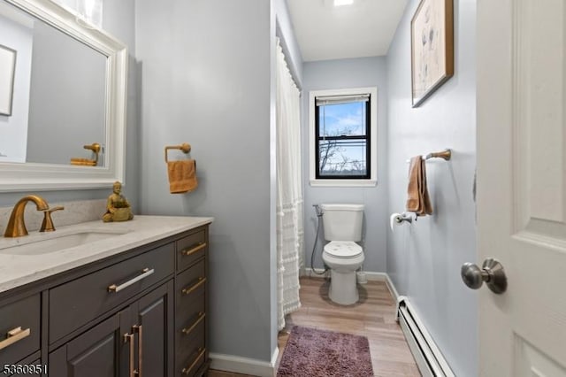 55 Jefferson St, Clifton City, NJ 07014 - bathroom with a baseboard radiator, toilet, vanity, wood finished floors, and baseboards