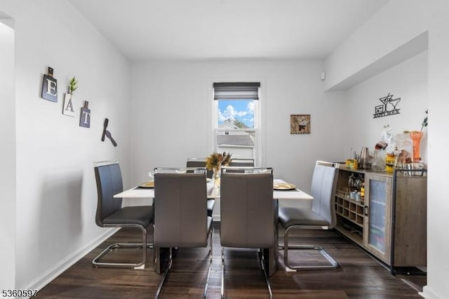 24-09 Raphael St, Fair Lawn Boro, NJ 07410 - dining space featuring dark wood-type flooring, a dry bar, and baseboards