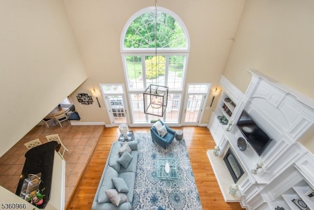 7 Briscoe Chase, Ringwood Boro, NJ 07456 - living room with a high ceiling, a glass covered fireplace, and wood finished floors