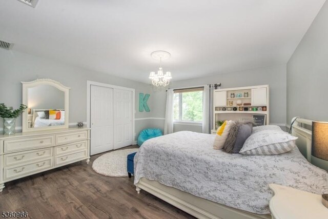 7 Briscoe Chase, Ringwood Boro, NJ 07456 - bedroom featuring dark wood-style flooring, a chandelier, and a closet