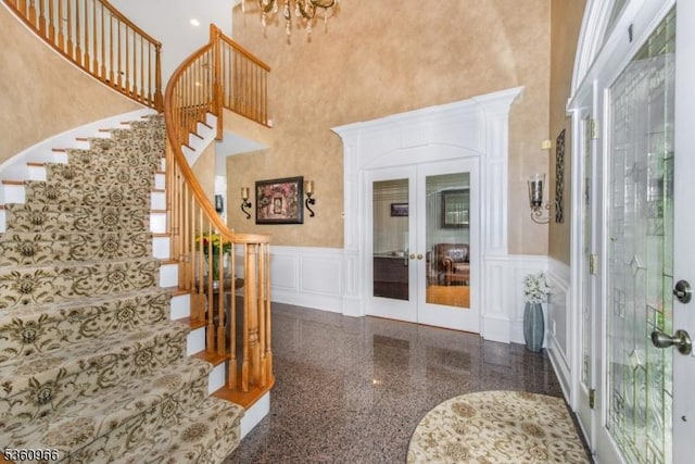 7 Briscoe Chase, Ringwood Boro, NJ 07456 - foyer entrance with a decorative wall, french doors, stairway, wainscoting, and a high ceiling