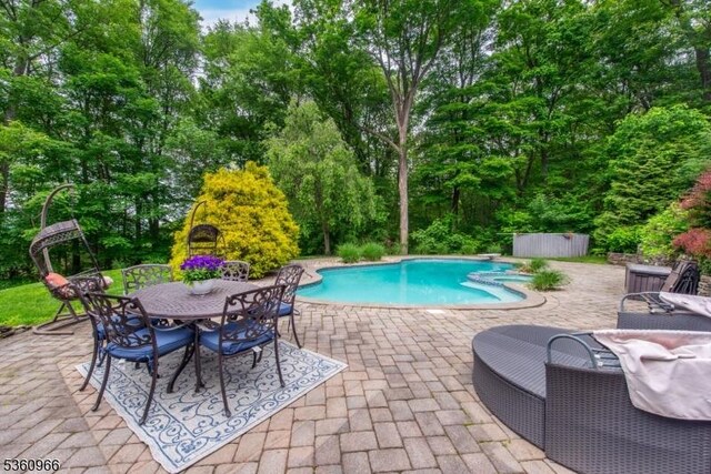 7 Briscoe Chase, Ringwood Boro, NJ 07456 - swimming pool with a patio area, view of wooded area, and outdoor dining area
