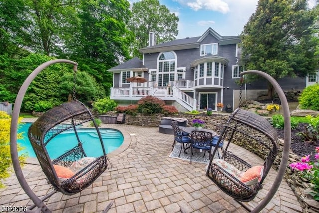 7 Briscoe Chase, Ringwood Boro, NJ 07456 - back of property with a patio, a chimney, a deck, an outdoor pool, and stairway