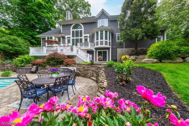 7 Briscoe Chase, Ringwood Boro, NJ 07456 - rear view of property featuring a deck, a patio area, a chimney, an outdoor pool, and stairs