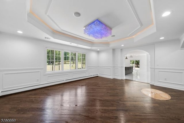 47 Cutlass Rd, Kinnelon Boro, NJ 07405 - unfurnished room with a tray ceiling, arched walkways, a decorative wall, a baseboard radiator, and wood finished floors