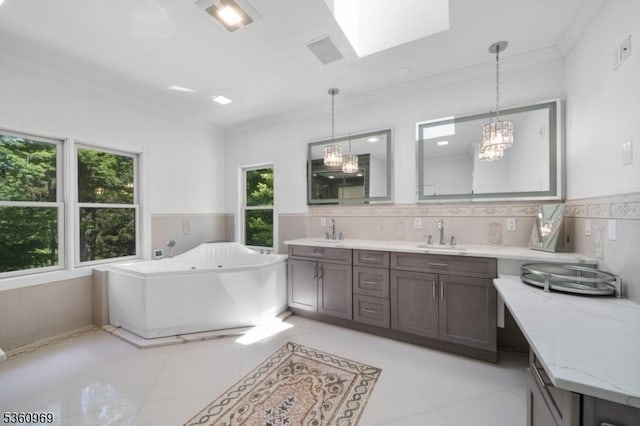 47 Cutlass Rd, Kinnelon Boro, NJ 07405 - bathroom featuring crown molding, a tub with jets, double vanity, a skylight, and tile patterned floors