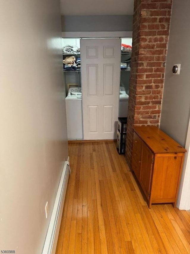 41-43 N 11th St, Paterson City, NJ 07522 - corridor featuring washer / dryer, light wood finished floors, and a baseboard heating unit