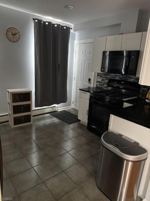 41-43 N 11th St, Paterson City, NJ 07522 - kitchen featuring black range with gas cooktop, baseboard heating, white cabinets, decorative backsplash, and dark countertops