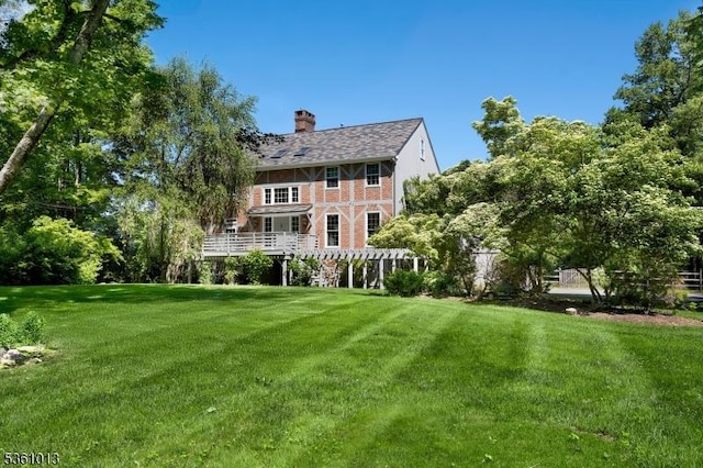 563 Cherry Valley Rd, Montgomery Twp, NJ 08540 - back of house with a chimney, a yard, and brick siding