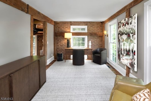 563 Cherry Valley Rd, Montgomery Twp, NJ 08540 - living area featuring healthy amount of natural light, wood finished floors, and brick wall